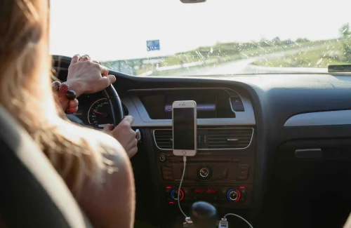 A woman driving with car phone holder